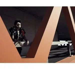 jacket by H&M, trousers by Niels Brinkman, folded collar by Niels Brinkman, leather arm-piece by Niels Brinkman, flower corsage Stylist’s Own