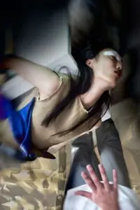 Anita wears tan & blue top, ripped skirt and leggings by Harold Kensington, jewellery by Charles Albert