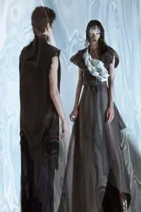 Anita wears coat by Mother of London, hands body piece by Mother of London, boots by Alexandra G, rings by Charles Albert